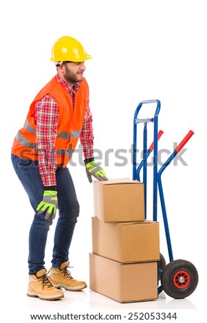 Accident at work. Manual worker holding knee in pain. Full length studio shot isolated on white.