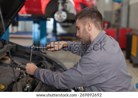 Fixing Car Engine with Ratchet Wrench