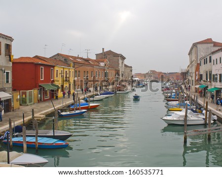 A cold cloudy day can\'t stop local and foreign tourists from visiting the colorful place of Murano,Italy.