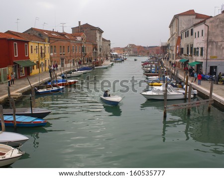 A cold cloudy day can\'t stop local and foreign tourists from visiting the colorful place of Murano,Italy.