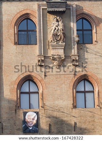 BOLOGNA, ITALY - DECEMBER 15, 2013 - A picture of Nelson Mandela hangs in Piazza Maggiore, Bologna\'s center, to commemorate the death of the South African leader and anti-apartheid revolutionary.