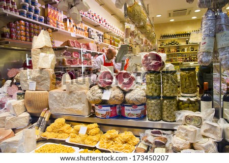 BOLOGNA, ITALY - JANUARY 25, 2014 - Vendors sell cheese and other quality Italian products at Bologna\'s famous markets located near the Piazza Maggiore.