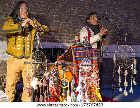 BOLOGNA, ITALY - JANUARY 25, 2014 - Native Indians sell native products while they perform at Piazza Maggiore in Bologna's center.