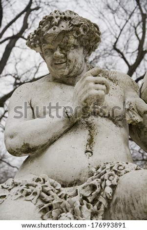 centuries old sculpture of an ugly fat man in Parma, Italy