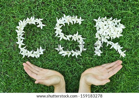 Flowers arranged in csr shape with supporting hands - corporate social responsibility