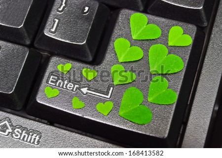computer keyboard covered with green heart shape leaves