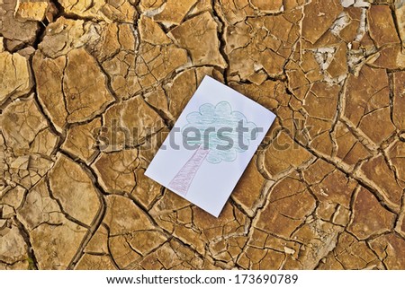 Drawing picture of a tree on cracked earth / tree growing on cracked earth / growing tree / save the world / environmental problems / cut tree / death
