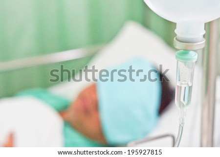 infusion bottle with patient in bed in hospital