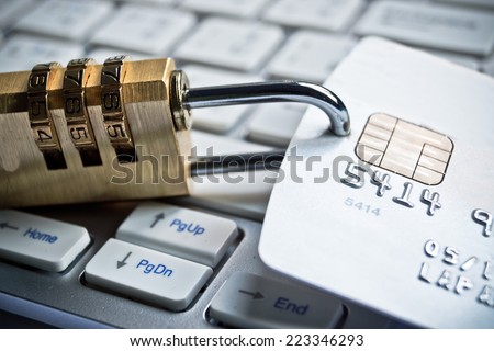 security lock on credit cards with computer keyboard - financial data theft protection