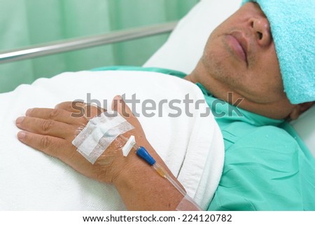 infusion bottle with patient in bed in hospital