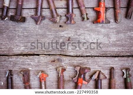 different types of drill bits on old wood background