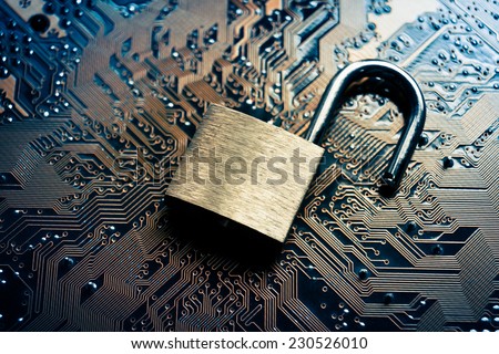 unlock security lock on computer circuit board - computer security breach concept