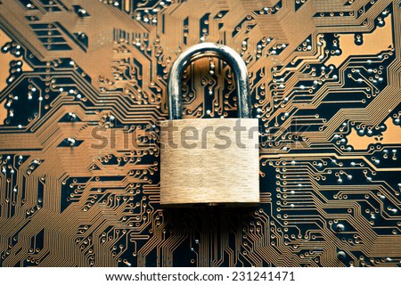 security lock on computer circuit board - computer security concept
