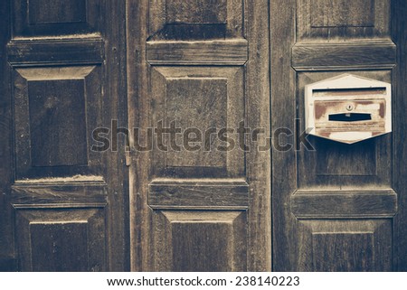 old wooden folding door with old mailbox
