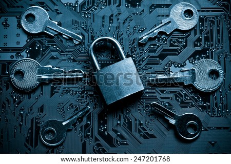 a security lock on a computer circuit board surrounded by keys / random password hacking concept