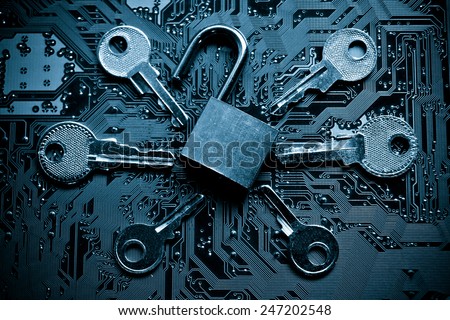 open security lock on a computer circuit board surrounded by keys / random password hacking attempt concept