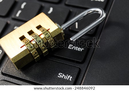 metal security lock with password on computer keyboard - security concept in computer