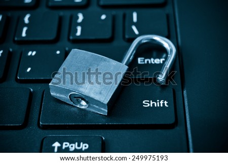 metal security lock left unlock on computer keyboard - security breach concept in computer