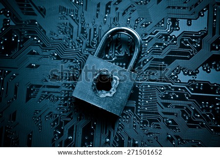 security lock with a hole on computer circuit board - computer security concept