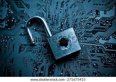 security lock with a hole on computer circuit board - computer security concept