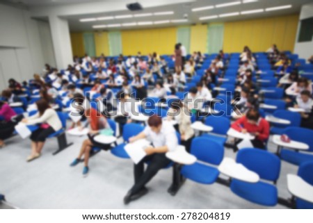 Abstract blurred background of students in a large lecture room