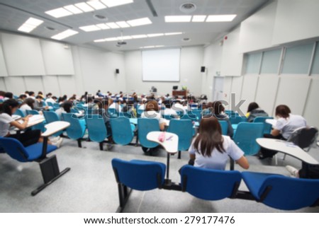 Abstract blurred background of students in a large lecture room