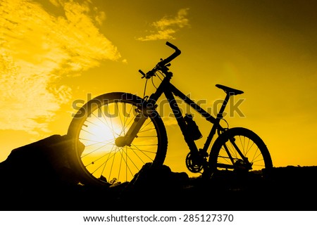 mountain bike with sunset silhouette