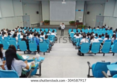 Abstract blurred background of university students in a large lecture room