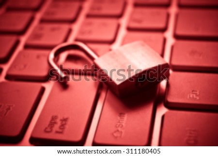 Abstract blurred background of a security lock on computer keyboard - computer security breach concept