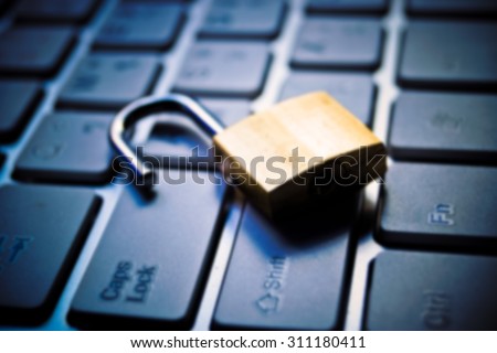 Abstract blurred background of a security lock on computer keyboard - computer security breach concept