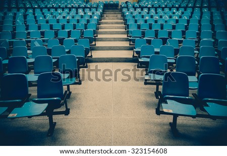 Lecture chairs in a class room with stair path in the middle of a class
