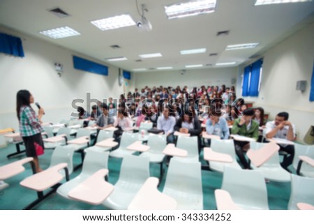 Abstract blurred background of university students in a large lecture room