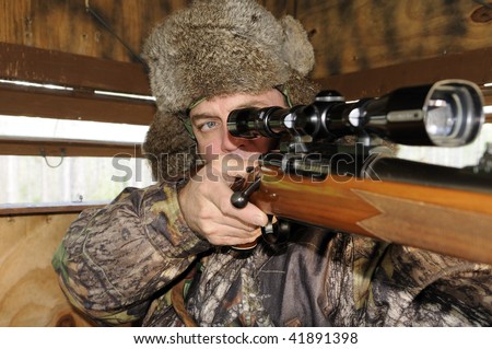 Man looking through hunting scope