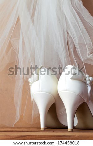 Wedding  shoes and veil. White wedding shoes and veil on the old wooden floor