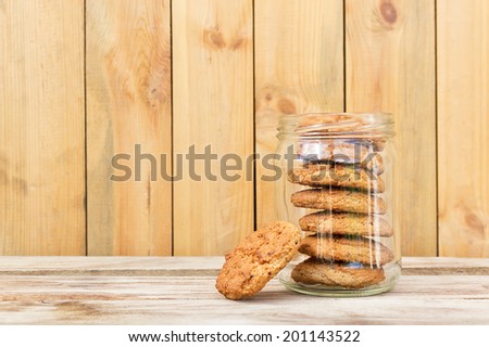 Oatmeal  cookies. Oatmeal cookies in glass jar on wooden table