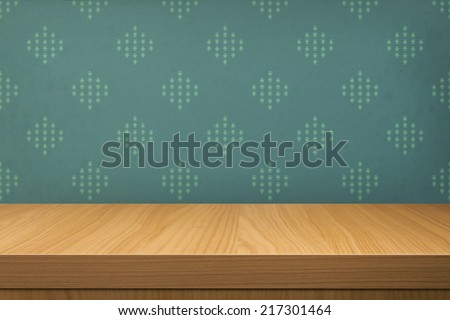 Empty wooden table over wallpaper with pattern. Ready for product montage display