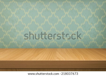 Empty wooden table over wallpaper  with pattern.  Ready for product montage display