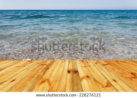 Wooden deck floor over beautiful sea background