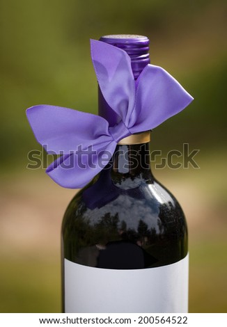 Red wine bottle with purple bow