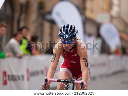 STOCKHOLM - AUG, 23:  World Triathlon  event Aug 23, 2014. woman bikes in Old town, Stockholm, Sweden. Magdalena Mielnik, POL.