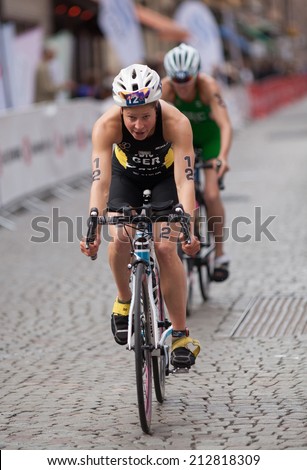 STOCKHOLM - AUG, 23:  World Triathlon  event Aug 23, 2014. woman bikes in Old town, Stockholm, Sweden. Rebecca Robisch, GER.