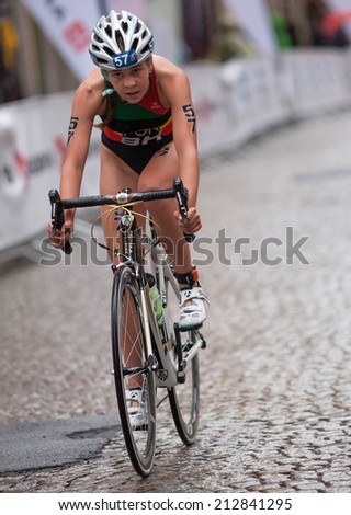 STOCKHOLM - AUG, 23:  World Triathlon  event Aug 23, 2014. woman bikes in Old town, Stockholm, Sweden.  Melanie Santos POR.
