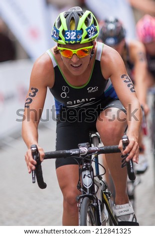 STOCKHOLM - AUG, 23:  World Triathlon  event Aug 23, 2014. woman bikes in Old town, Stockholm, Sweden. Mateja Simic, Slo.