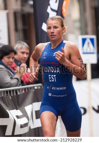 STOCKHOLM - AUG, 23:  World Triathlon  event Aug 23, 2014. woman running in Old town, Stockholm, Sweden.  Kaidi Kivioja, EST.
