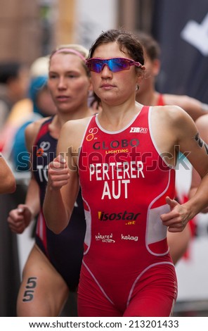 STOCKHOLM - AUG, 23:  World Triathlon  event Aug 23, 2014. woman running in Old town, Stockholm, Sweden. Lisa Perterer AUT.