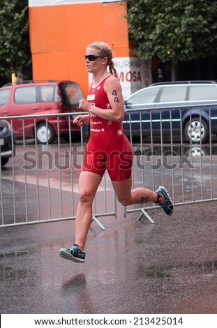 STOCKHOLM - AUG, 23:  World Triathlon  event Aug 23, 2014. woman running in Old town, Stockholm, Sweden. Celine Schaerer,  SUI.