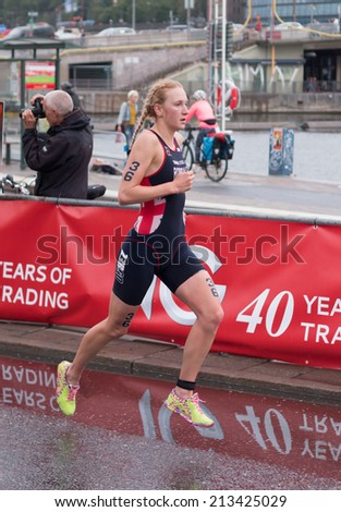 STOCKHOLM - AUG, 23:  World Triathlon  event Aug 23, 2014. woman running in Old town, Stockholm, Sweden. Lois Rosindale, GBR.