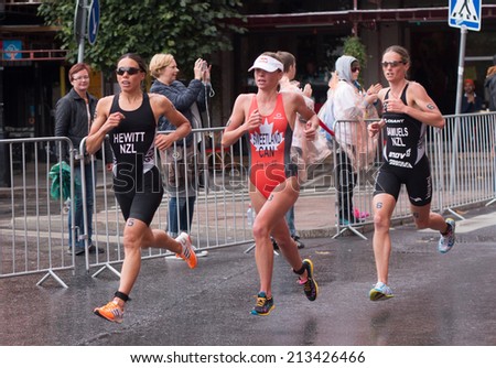 STOCKHOLM - AUG, 23:  World Triathlon  event Aug 23, 2014. woman running in Old town, Stockholm, Sweden.  Andrea Hewitt NZL. Nicky Samuels, NZL. Kirsten Sweetland, CAN.