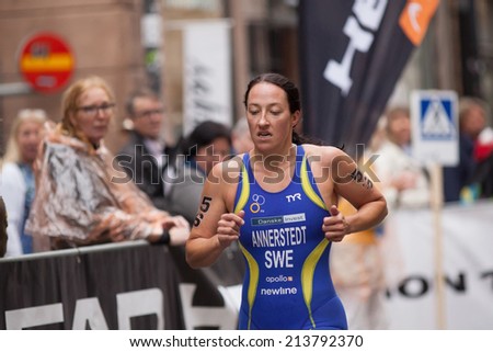 STOCKHOLM - AUG, 23:  World Triathlon  event Aug 23, 2014. woman running in Old town, Stockholm, Sweden.  Asa Annerstedt, Sweden