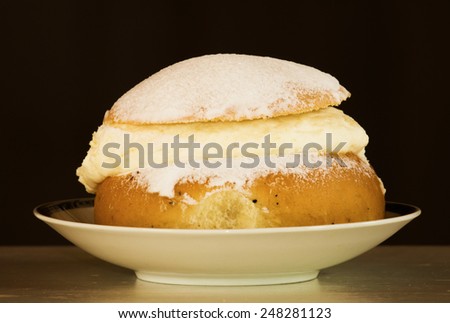A typical Swedish cream bun filled with almond paste and cream